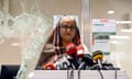 Sheikh Hasina giving press conference in front of smashed glass window.