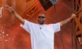 Killer Mike in a white t-shirt, arms raised, on stage in Quebec City, July 2024.