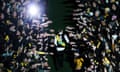 Fans reach over Dustin Martin who stands with his back to the camera