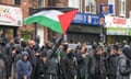 Crowds of men, some wearing masks, in Bordesely Green, Birmingham, on Monday.
