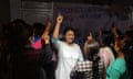 Devi Khadka, holding up her hand among a group of women in the documentary film Devi.
