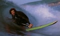 A man surfing a barrel wave