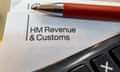 HM Revenue & Customs note paper with a pen and keyboard
