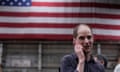 man talks on the phone in front of american flag