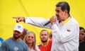 People hold anti-Maduro signs in the air.
