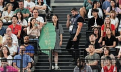 Angelina Yang holds a banner supporting Taiwanese athletes at the Paris Olympics. 