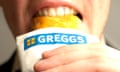 A man enjoying his recently purchased Greggs sausage roll