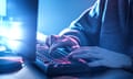 Hands of teenage boy using computer on desk.