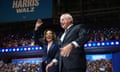 Man and woman smile on stage at convention center
