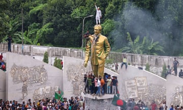 Protesters in Dhaka climb a public monument to the assassinated first premier of Bangladesh, the father of Sheikh Hasina as they celebrate the news of her resignation as prime minister.
