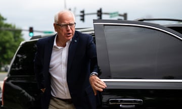 a man in a suit leaves a vehicle