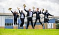 Five students jump in the air with their results