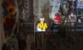 A vendor shines a flashlight during a power outage in an underground shopping mall