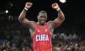 Cuba's Mijaín López Nunez raises his arms in triumph after beating Chile's Yasmani Acosta Fernandez to win gold in the 130kg final