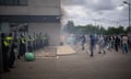 Riot police officers stand off against anti-immigration protesters outside the Holiday Inn Express Hotel which is housing asylum seekers in Rotherham.